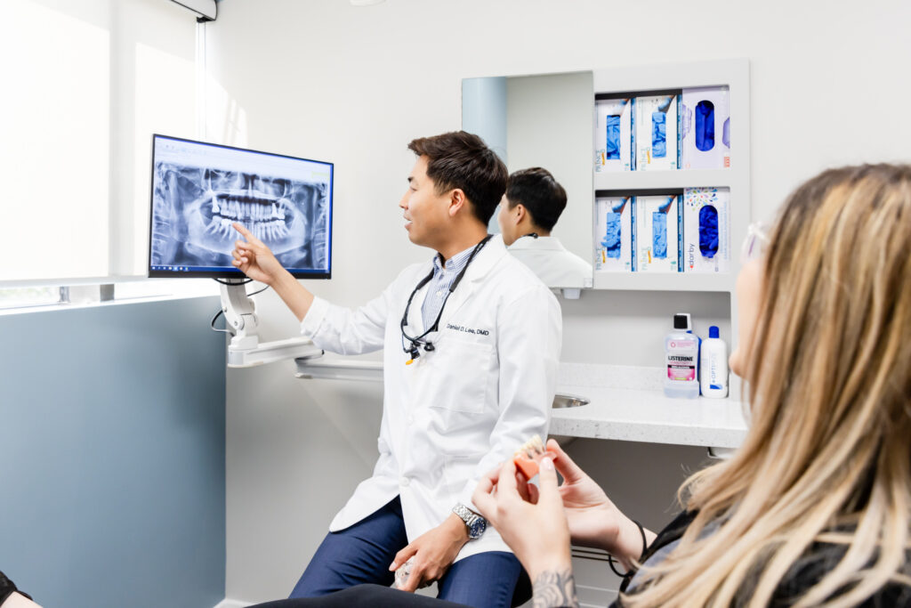 dentist showing a patient her x-ray during a consultation for dental implants in Herndon, VA.